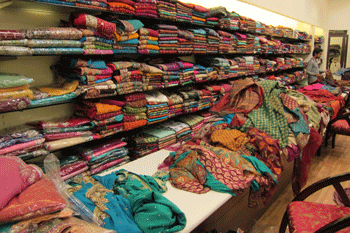 fabrics shelves with fabrics in sari shop in India