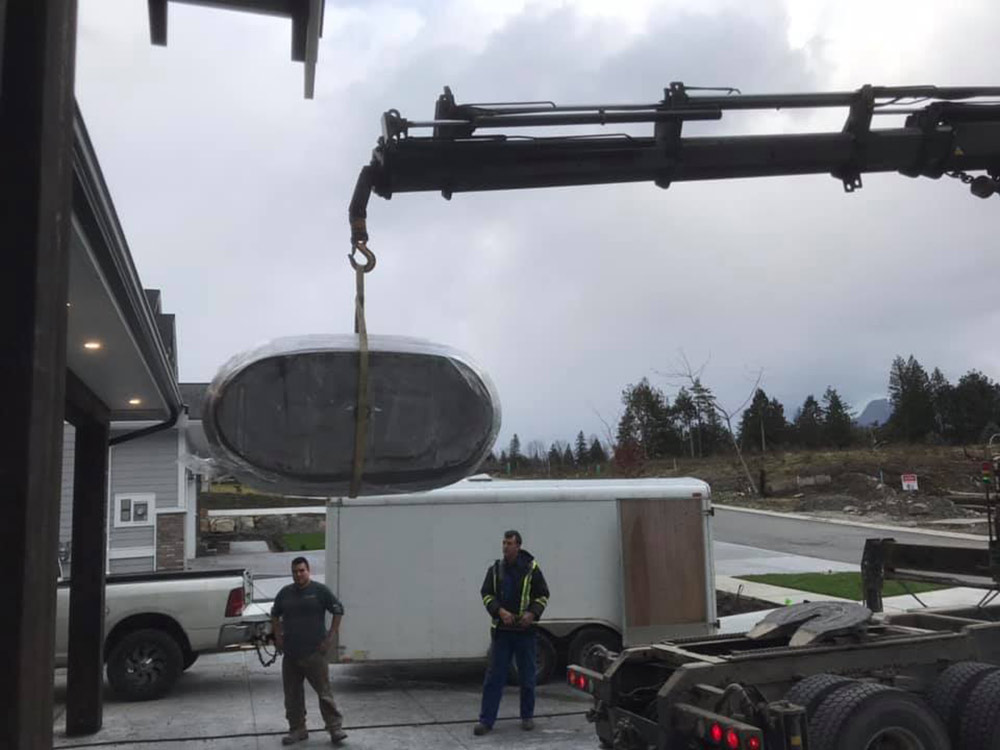 lifting concrete tub made by Diamond Finish Concrete with crane